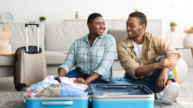 A couple packing their suitcases for a trip