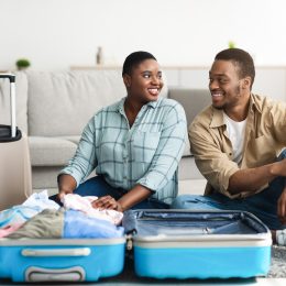 A couple packing their suitcases for a trip