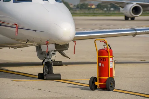 Verona, Italy - September 2018: Fire extinguisher in front of the nose of a Cessna Citation private executive jet parked at Verona airport