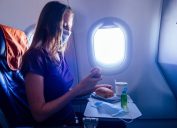 Passenger looking down at food on airplane