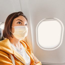 Girl wearing mask on a plane