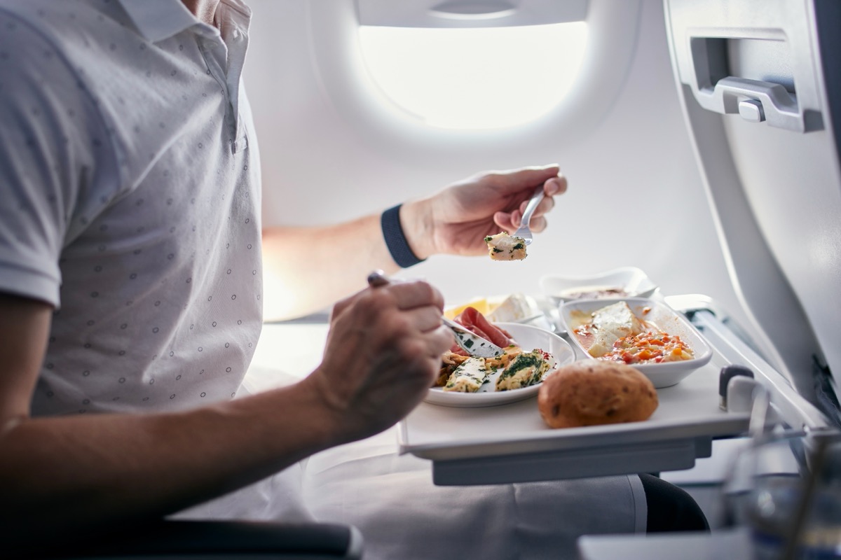 Passenger eating meal on plane