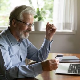 older man shopping online with credit card