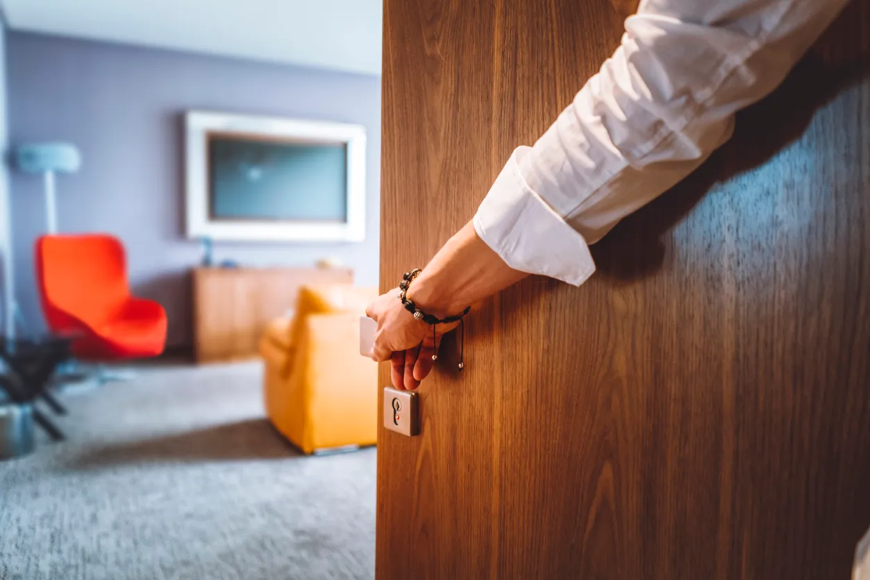 A person entering a hotel room