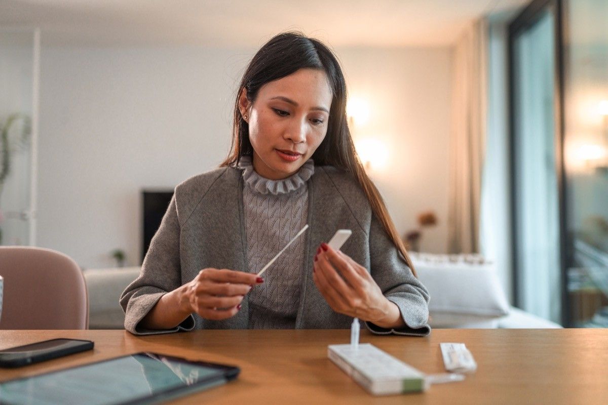 Woman Holding Covid Rapid Test And Waiting For Results At Home