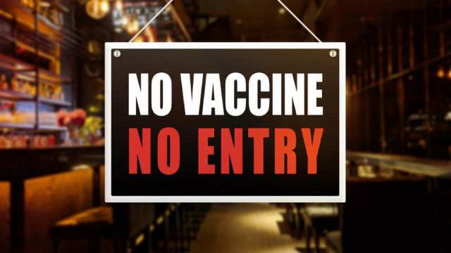 sign on door that says no vaccine no entry