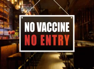 sign on door that says no vaccine no entry