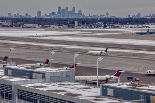 Planes at MSP International Airport with the Minneapolis Skyline