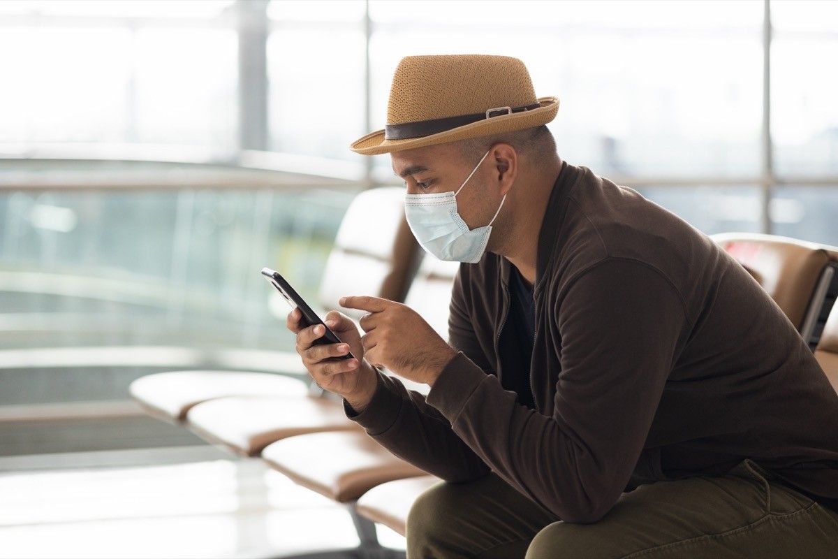 Young traveler man wearing mask protect flu coronavirus.