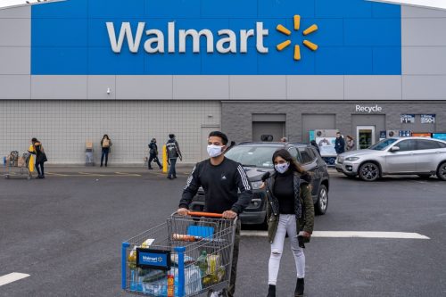 People exit the Walmart store on December 24, 2020 in Valley Stream, NY.