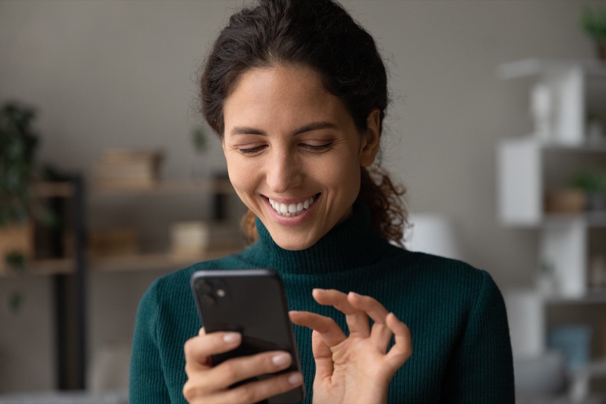 young woman clicking screen on phone