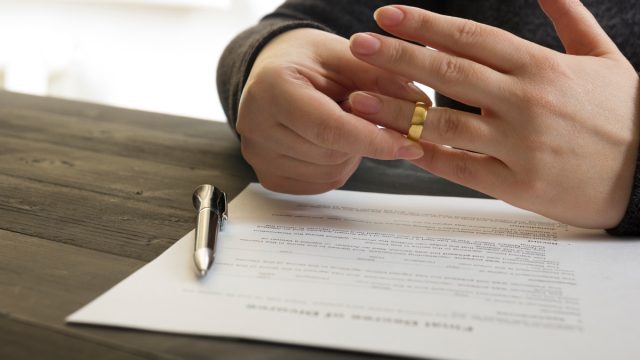 Woman removes wedding ring while filing for divorce
