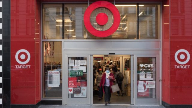 A woman wearing a mask exits a Target store in Midtown.