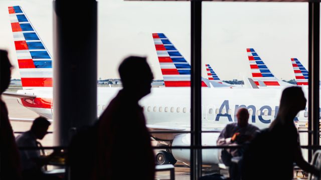 American Airlines fleet of airplanes with passengers at O'Hare Airport
