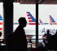 American Airlines fleet of airplanes with passengers at O'Hare Airport