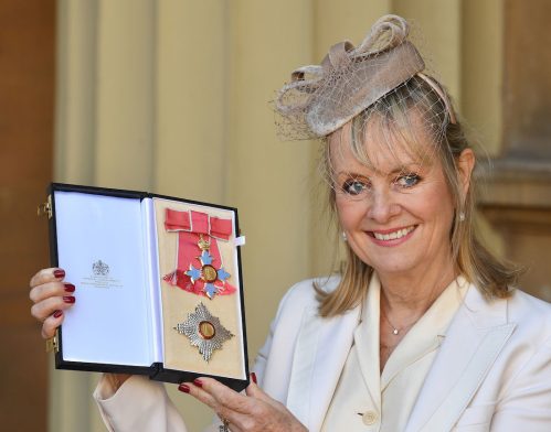 Twiggy holding her Dame Commander of the Order of the British Empire award in 2019