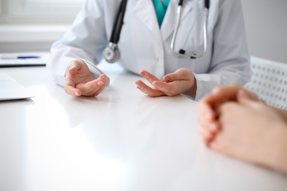 Close-up of doctor's hands while explaining to patient