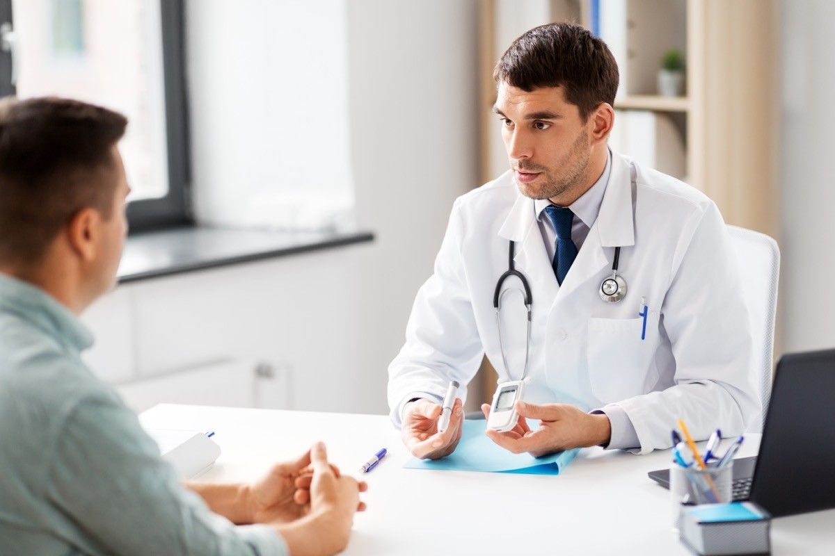 Man talking to doctor about being screened for diabetes