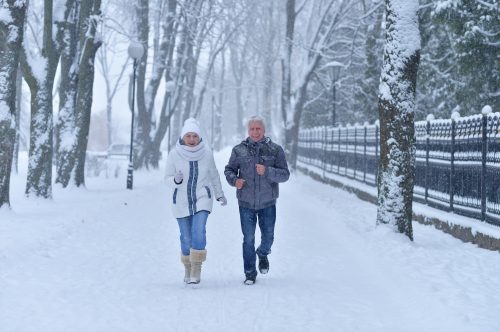 Older couple walking in snow