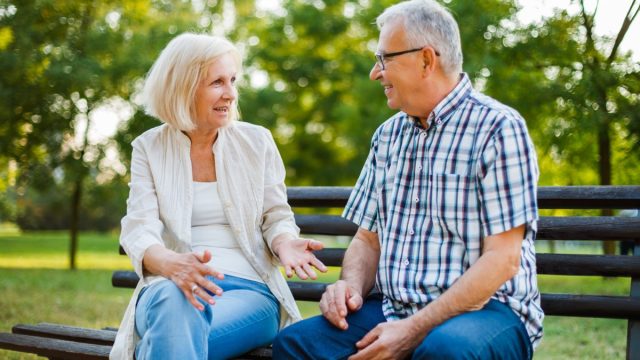 Two,Happy,Seniors,Are,Sitting,And,Talking,In,Park.