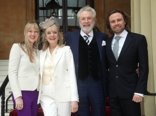 Twiggy with daughter Carly, stepson Jason, and husband Leigh Lawson at her damehood ceremony in 2019