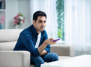 Young man at home sofa sitting - stock photo
