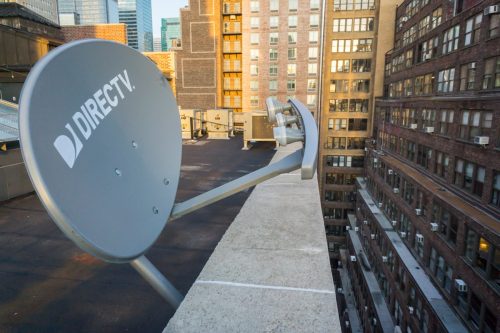 A DirecTV satellite dish on the rooftop of a building in New York
