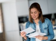 Portrait of a woman reading her mail at home and looking very happy - domestic lifestyle concepts