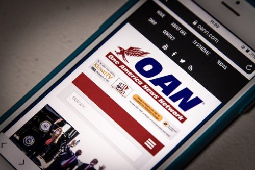 the website of One America News Network(OANN), a channel owned by Herring Networks, Inc., on iPhone.