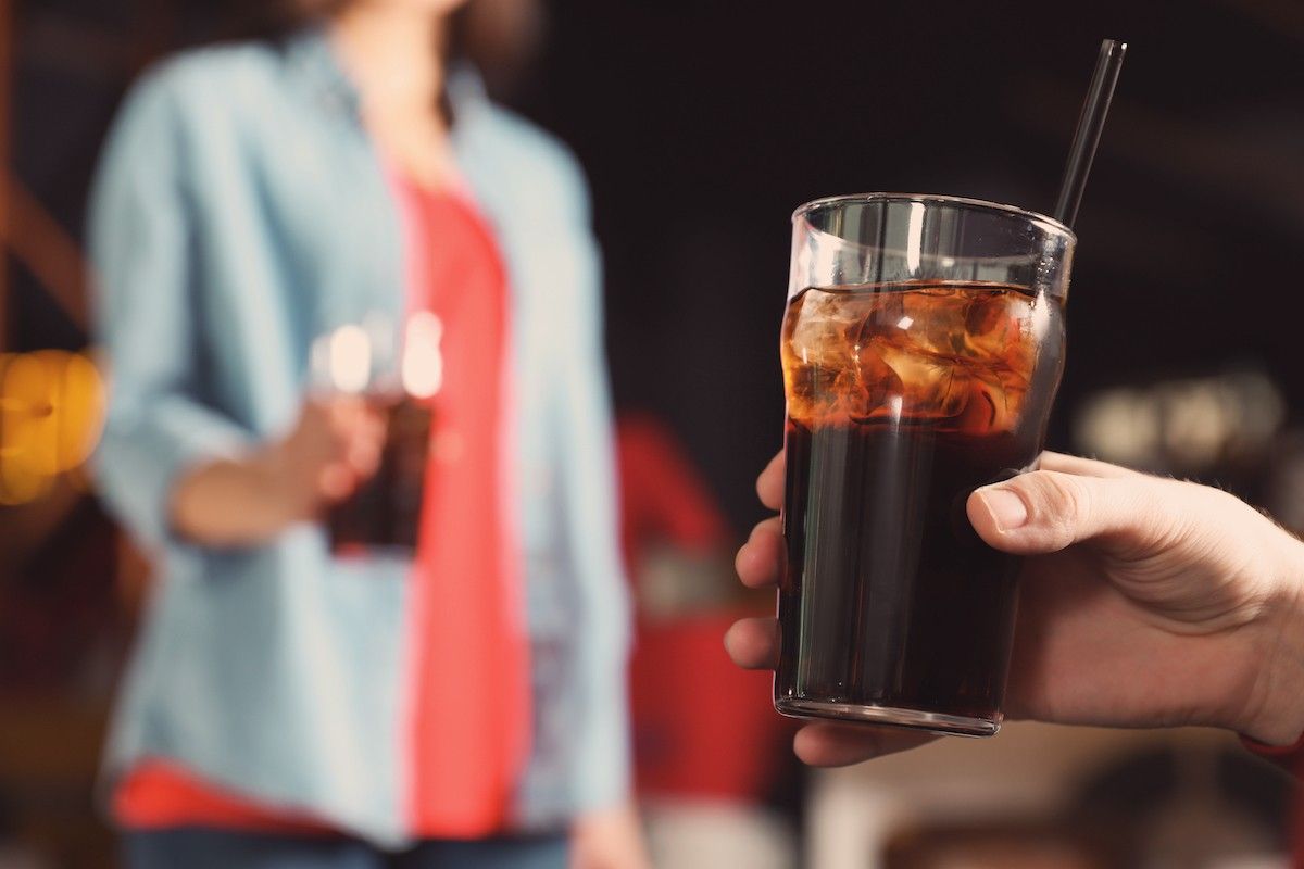 Two People Drinking Soda.