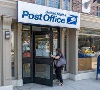 A woman enters a United States Postal Service (USPS) post office in Long Island City on August 17, 2020 in Queens Borough of New York City.