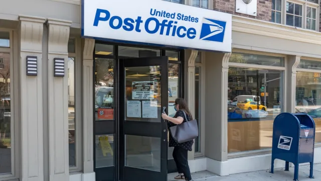 A woman enters a United States Postal Service (USPS) post office in Long Island City on August 17, 2020 in Queens Borough of New York City