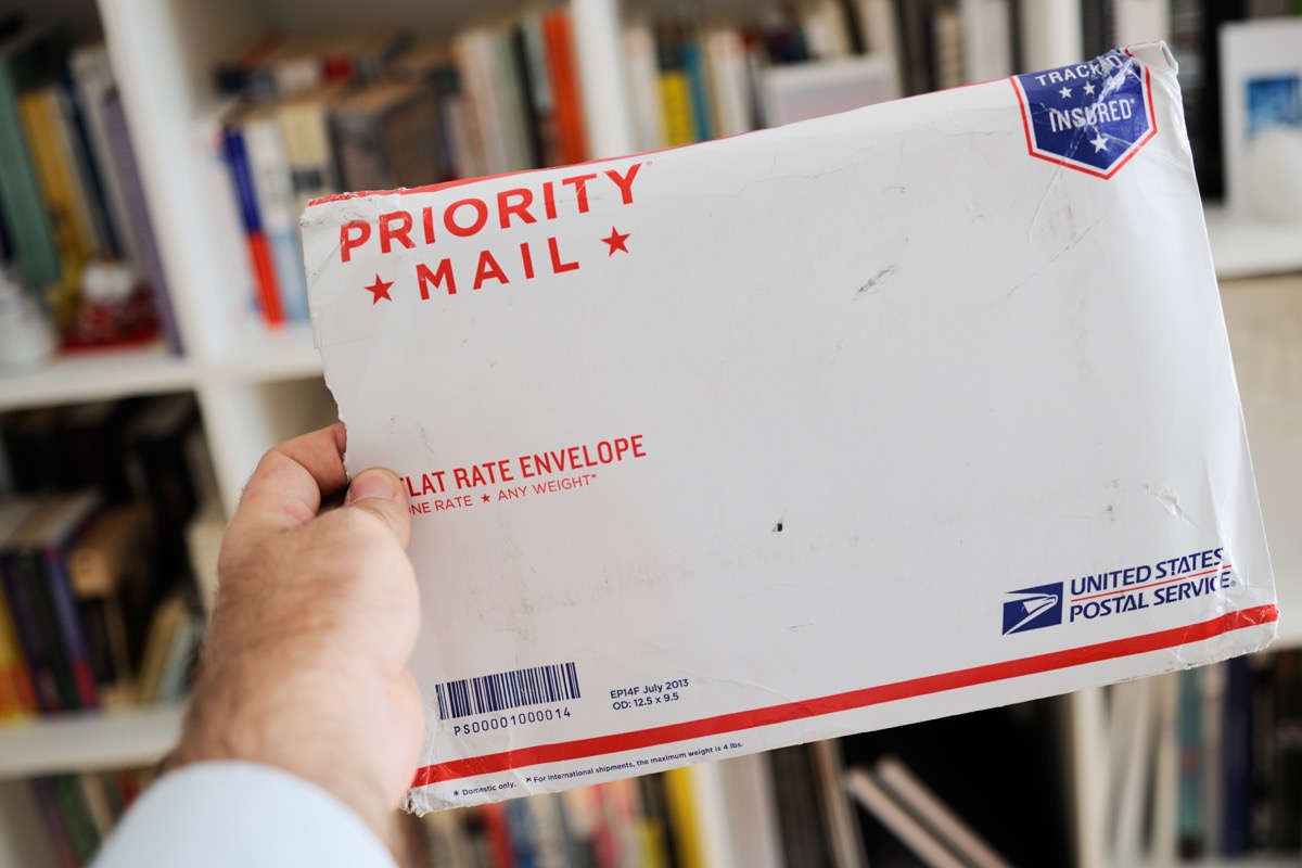 USPS United States Postal Service Parcel envelope in man