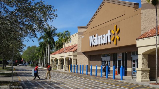 people coming out of a Walmart store on a sunny day