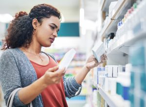 A woman shopping in the pharmacy for over-the-counter medication