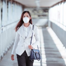 woman are going to work.she wears N95 mask.prevent PM2.5 dust and smog