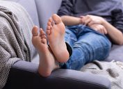 Man resting on couch with feet up