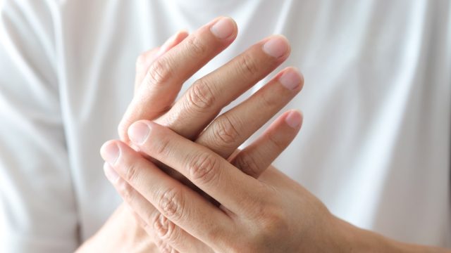 Closeup of woman's hands pain discomfort