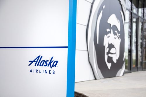 Alaska Airlines sign and logo at the company headquarters, with space for text