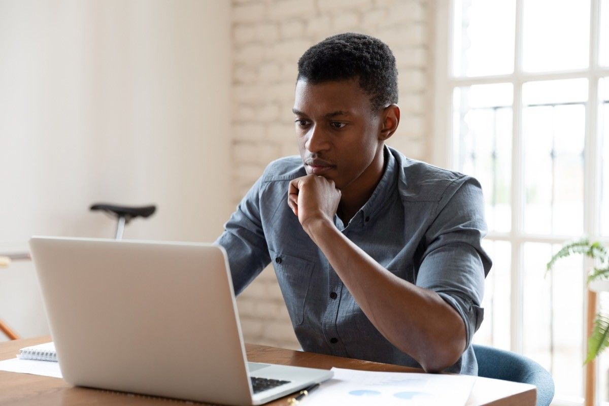 worker sit in front of laptop reading e-mail