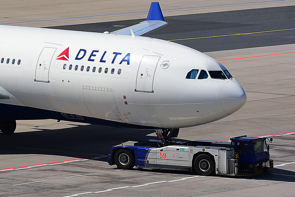 A Delta Air Lines plane taxiing on a runway