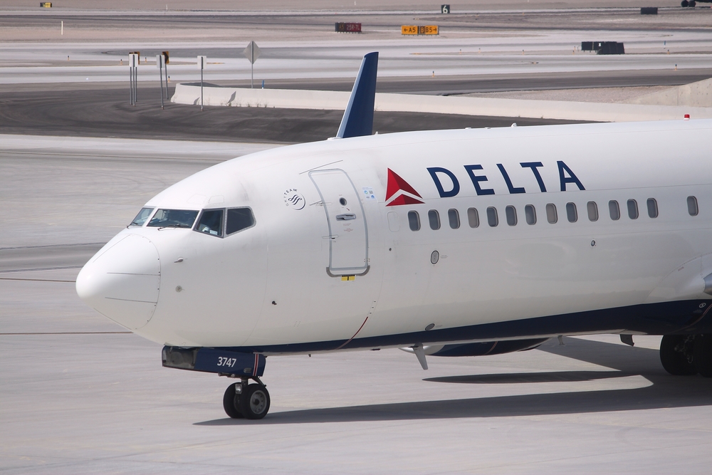 A Delta Air Lines plane on the runway at an airport