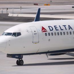 A Delta Air Lines plane on the runway at an airport