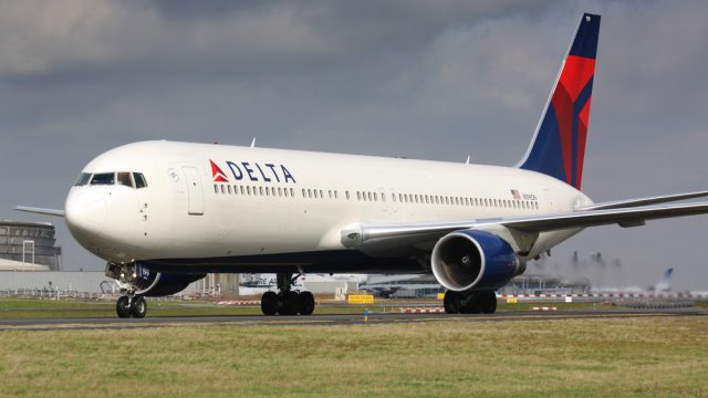 A Delta Air Lines plane sitting on a runway