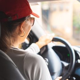Rear view of woman driving a car