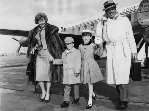 Lucille Ball, Desi Arnaz Jr, Lucie Arnaz, and Desi Arnaz getting off of a plane in London in 1959