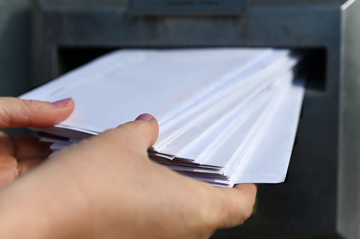 Woman hands sending many invitation letters.