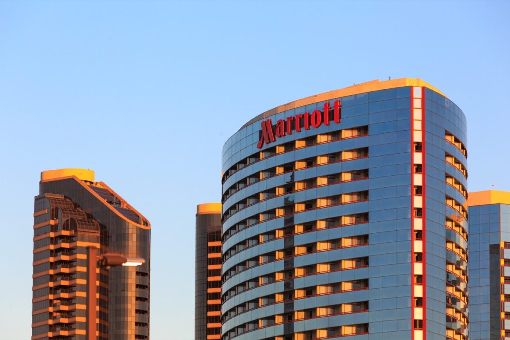 Building Sign on Marriott Hotel , red letters on a glass tower.