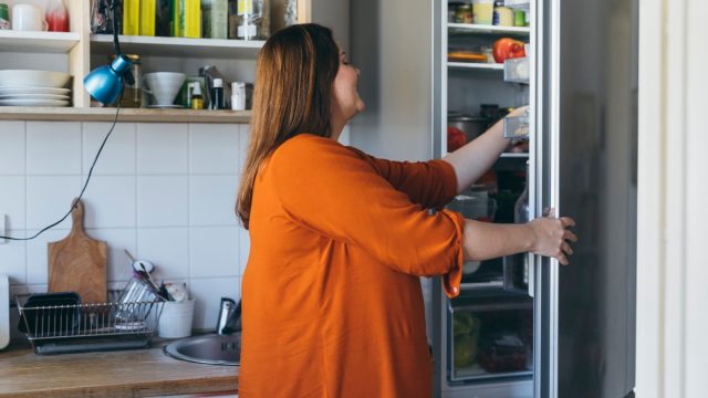 woman taking something from the fridge to make breakfast in the kitchen
