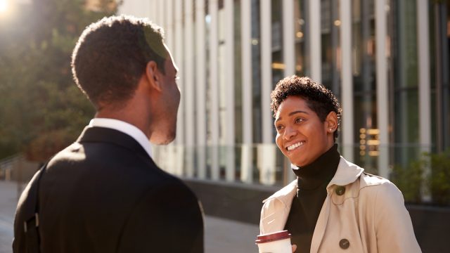 smiling woman talking to a businessman